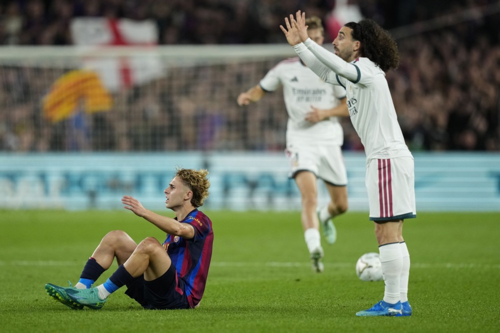Marc Cucurella – 6.8/10: Khá vất vả trước sự lắt léo của Lamine Yamal nhưng vẫn giữ vị trí kỷ luật, hạn chế tối đa mối nguy hiểm từ cánh này. Ảnh: EPA.

Aurelien Tchouameni – 6.7/10: Làm tròn nhiệm vụ ở khu trung tuyến với tỷ lệ chuyền bóng chính xác lên tới 96% (44/46 đường chuyền), giúp che chắn hiệu quả cho hàng thủ. Ảnh: EPA.

Bernardo Silva – 6.4/10: Tích cực phòng ngự từ xa, cầm nhịp và thoát pressing trong bối cảnh Real giữ ít bóng, thi đấu bền bỉ đến phút 80. Ảnh: EPA.

Arda Guler – 7/10: Mối đe dọa thường trực bên cánh phải với 5 cú sút (3 lần trúng đích), chỉ thiếu một chút sắc bén để có bàn thắng. Ảnh: EPA.

Jude Bellingham – 7.2/10: Gây ấn tượng ở khối lượng vận động và phong tỏa nhạc trưởng Rodri của Barca nhiều hơn là khâu tấn công; bỏ lỡ một cơ hội dứt điểm ở phút 78. Ảnh: EPA.

Yan Diomande – 7/10: Chăm chỉ hỗ trợ phòng ngự bên cánh trái, có một nỗ lực phản công nguy hiểm cuối hiệp một trước khi rời sân nhường chỗ cho Carlos Espi. Ảnh: EPA.

Kylian Mbappe – 8.3/10 (Cầu thủ xuất sắc nhất trận): Ngôi sao người Pháp định đoạt trận Siêu kinh điển với cú đúp (phút 41 và 87), chính thức chạm mốc 100 bàn thắng trong màu áo Real Madrid.